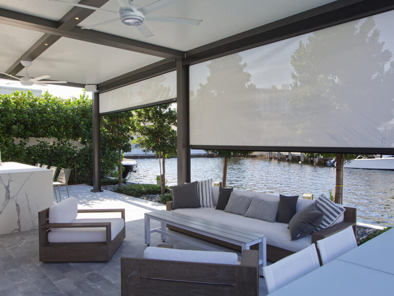 R-SHADE™ R-SHADE™ insulated patio cover with motorized screens and outdoor seating area.