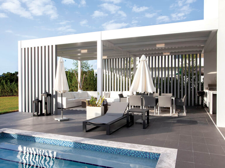 R-SHADE™ R-SHADE™ insulated patio cover providing shade and comfort over outdoor living space with pool and lounge furniture.