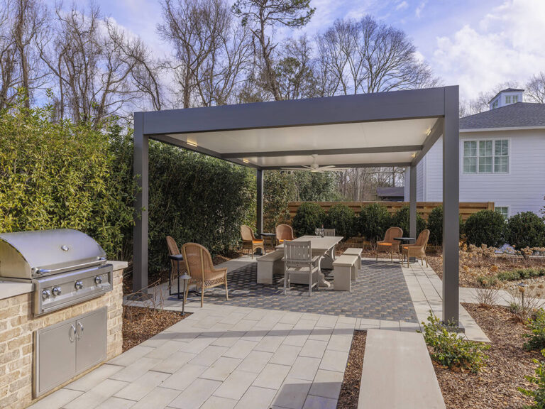 R-SHADE™ R-SHADE™ insulated patio cover providing shade and outdoor living space with grill and seating area.