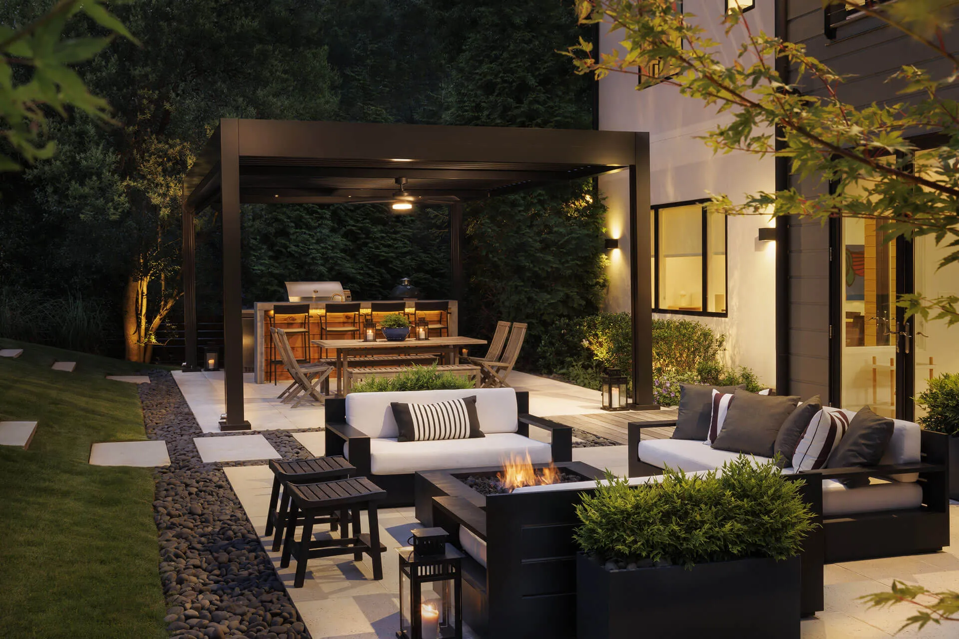 Family enjoying the benefits of a motorized louvered pergola in a sunny outdoor setting